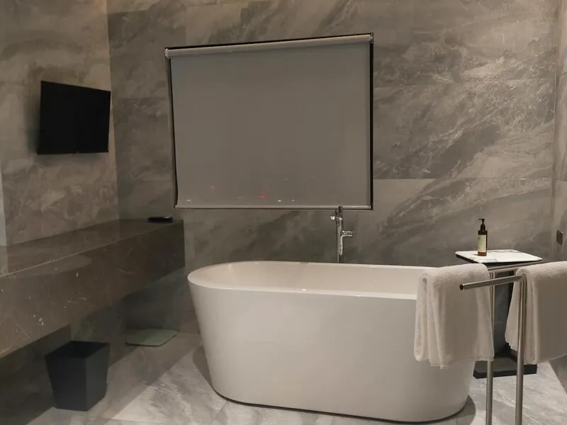 Freestanding soaking tub with marble walls, Carrboro spa bathroom by Ridgeway