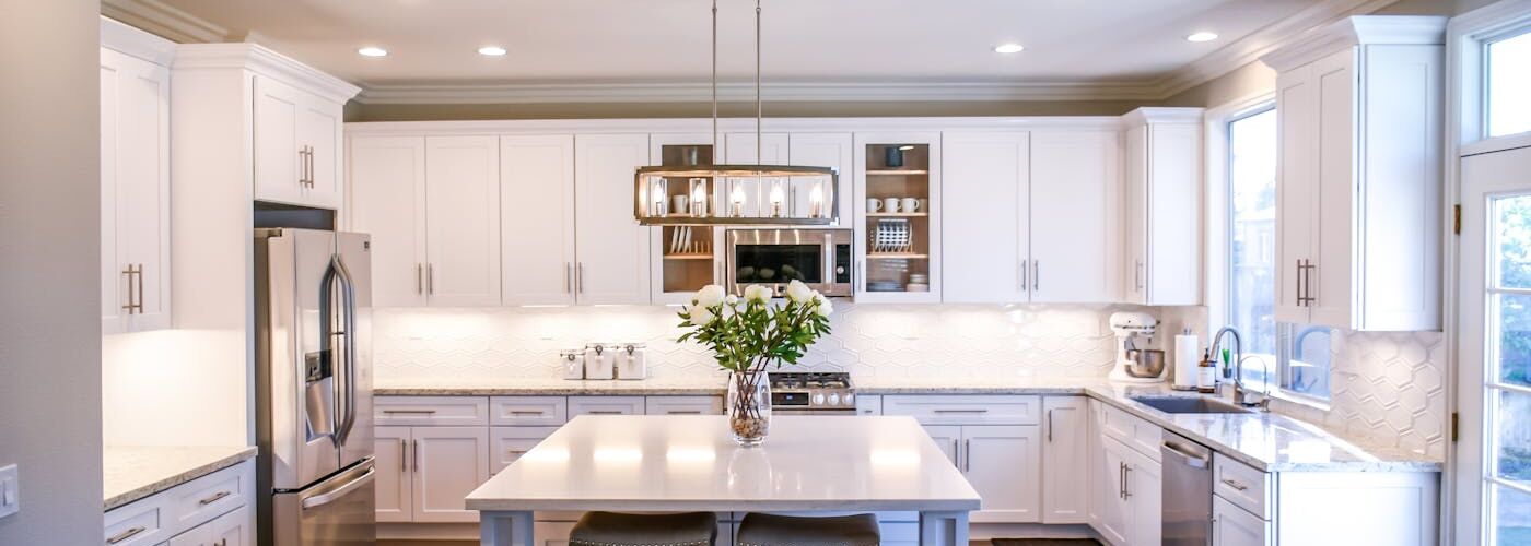 Bright white kitchen with island and pendant lighting, Hillsborough full remodel by Ridgeway