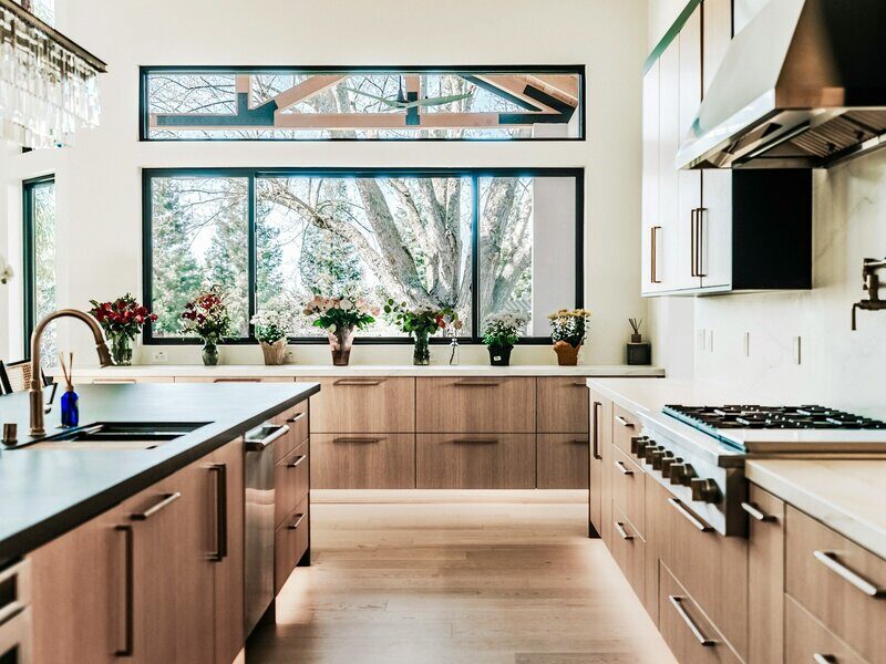 Modern kitchen with warm walnut cabinetry and large windows, Pittsboro kitchen by Ridgeway