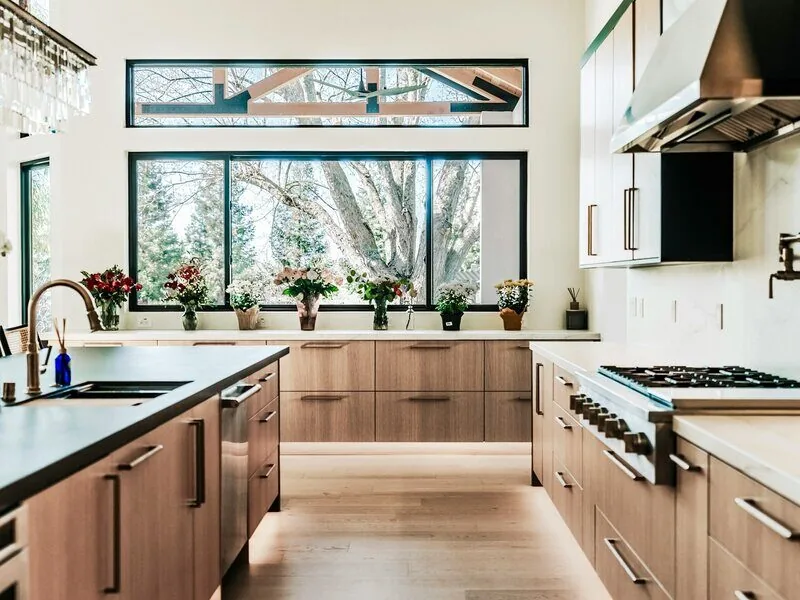 Modern kitchen with warm walnut cabinetry and large windows, Pittsboro kitchen by Ridgeway